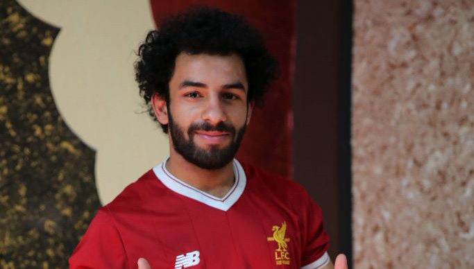 Iraqi footballer Hussein Ali, who plays for the Iraqi Al-Zawraa FC and is a lookalike of Liverpool's Egyptian forward Mohamed Salah, poses for pictures in the capital Baghdad, on June 4, 2018. - With his black beard, curly hair and football shirt, Iraqi striker Hussein Ali is often mistaken for one of the world's top players: Egypt's Mohamed Salah. (Photo by SABAH ARAR / AFP)        (Photo credit should read SABAH ARAR/AFP/Getty Images)