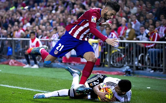 atletico-madrid-winger-yannick-carrasco-is-tripped-by-valencia-defender-jo-o-cancelo