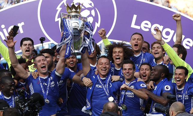 Chelsea's John Terry and Gary Cahill celebrate with the trophy and teammates after winning the Premier League