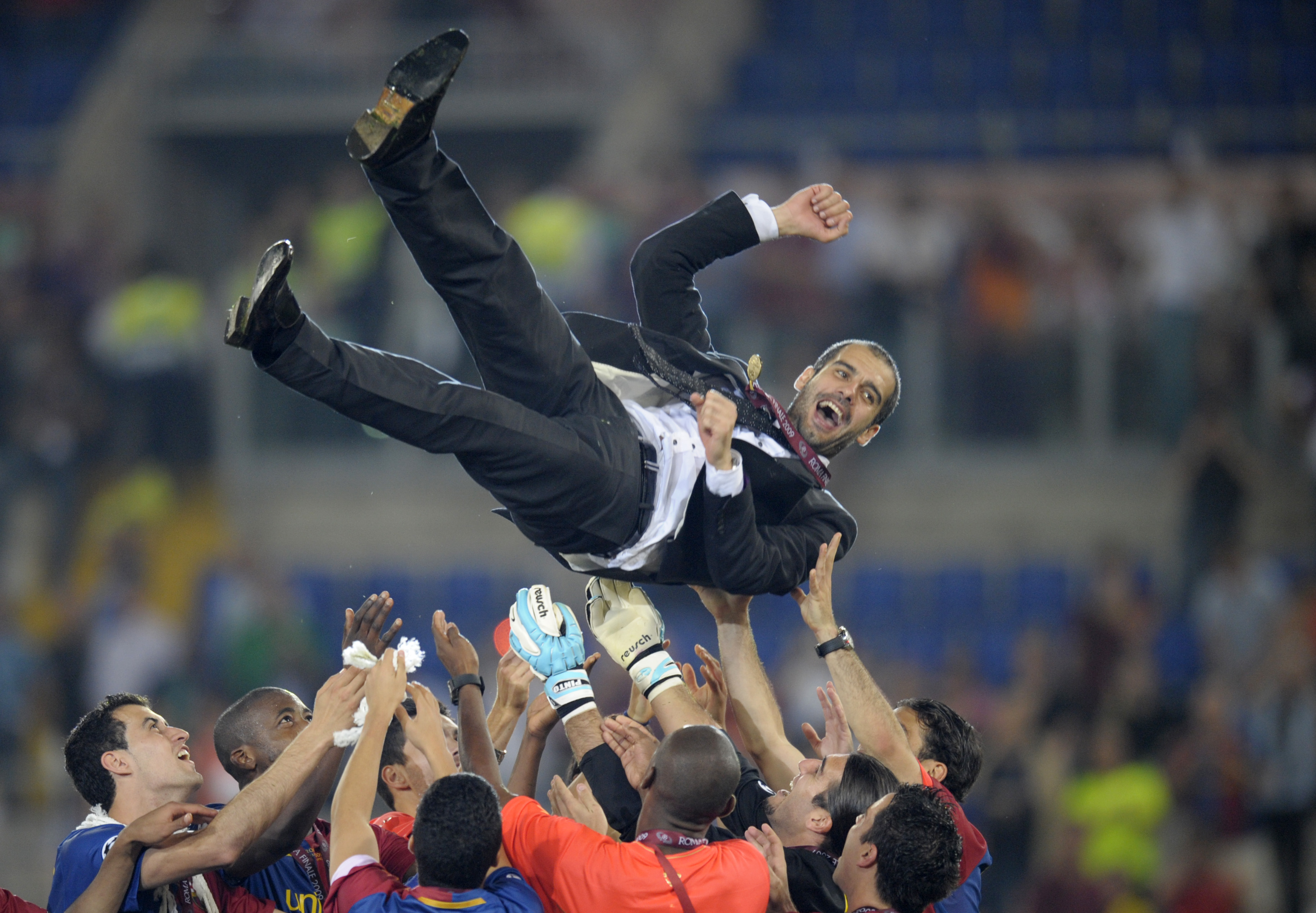 Barcelona´s players celebrate with their coach Josep Guardiola (top) after winning the Champions League Cup on May 27, 2009 at the Olympic Stadium in Rome. Barcelona defeated  Manchester United 2-0 in the final of the UEFA football Champions League.      AFP PHOTO / LLUIS GENE (Photo credit should read LLUIS GENE/AFP/Getty Images)