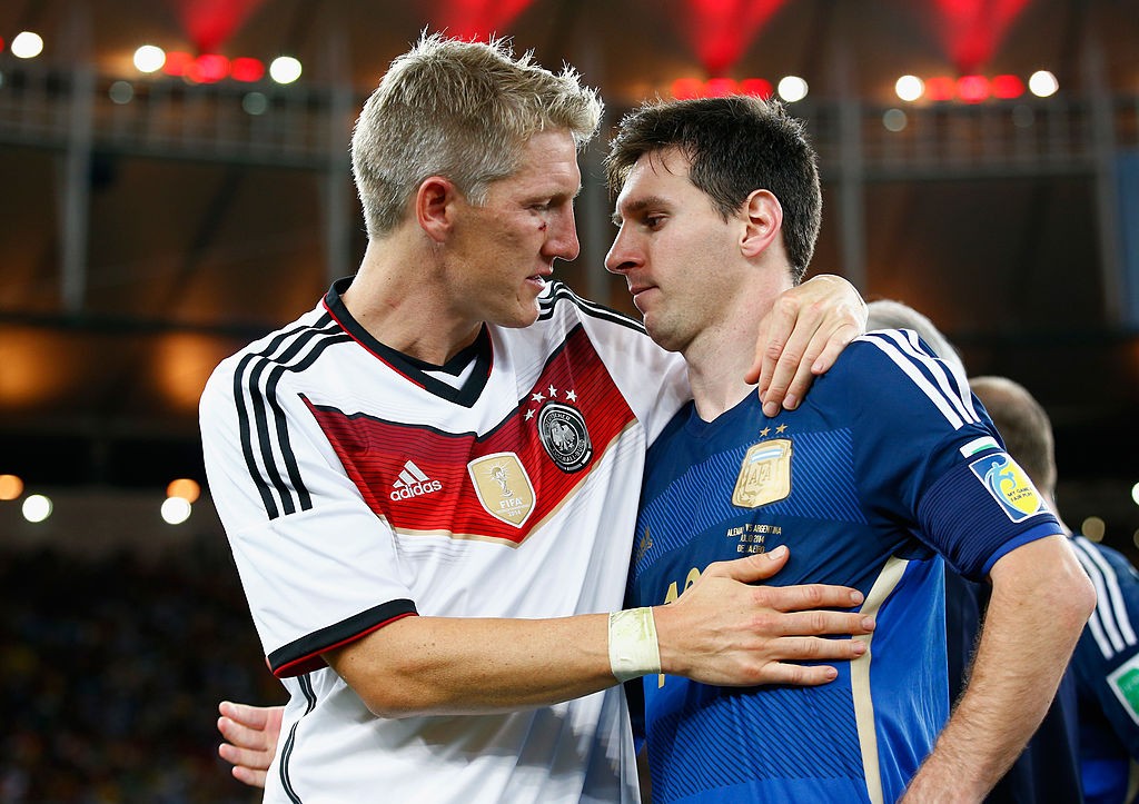 RIO DE JANEIRO, BRAZIL - JULY 13: Bastian Schweinsteiger of Germany hugs Lionel Messi of Argentina after Germany's 1-0 victory in extra time during the 2014 FIFA World Cup Brazil Final match between Germany and Argentina at Maracana on July 13, 2014 in Rio de Janeiro, Brazil. (Photo by Clive Rose/Getty Images)