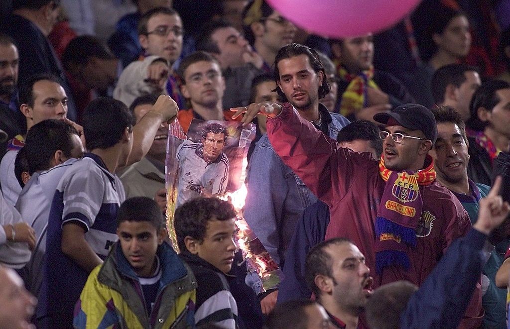 Barcelona supporters burn a portrait of Portugese
